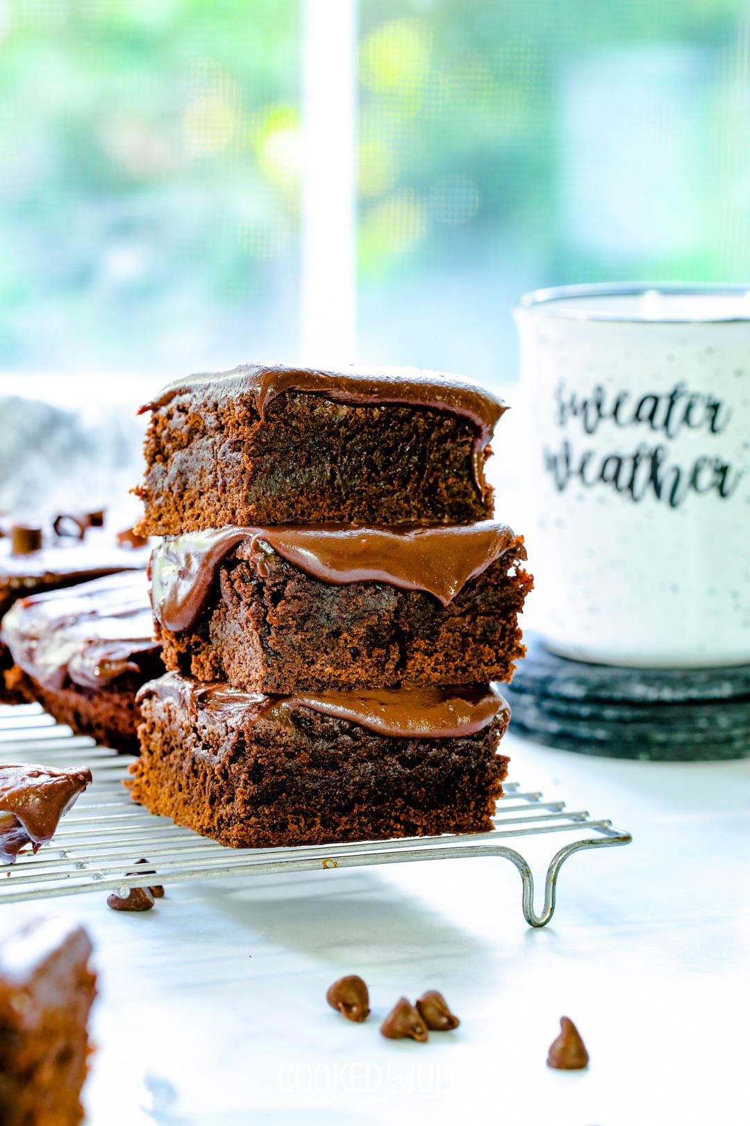 three chocolate fudge brownies stacked 