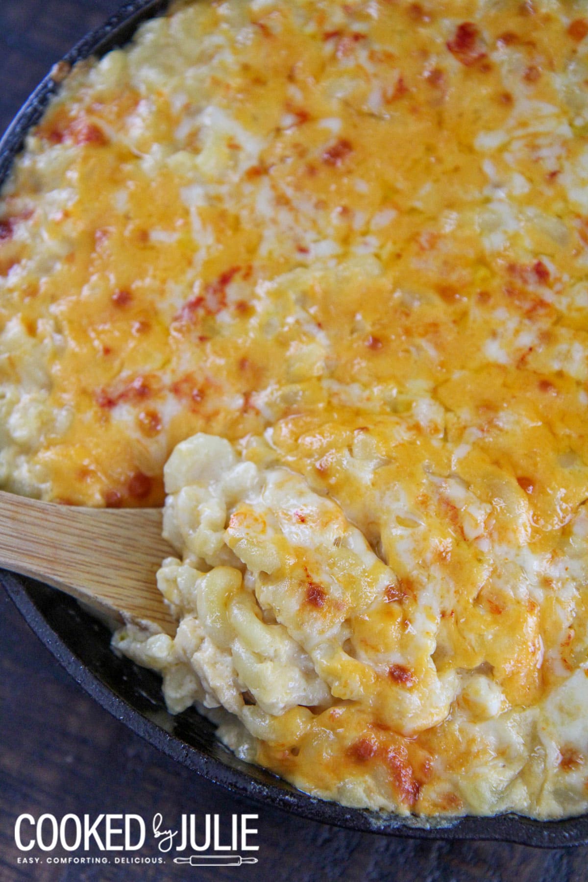 mac and cheese with a wooden spoon