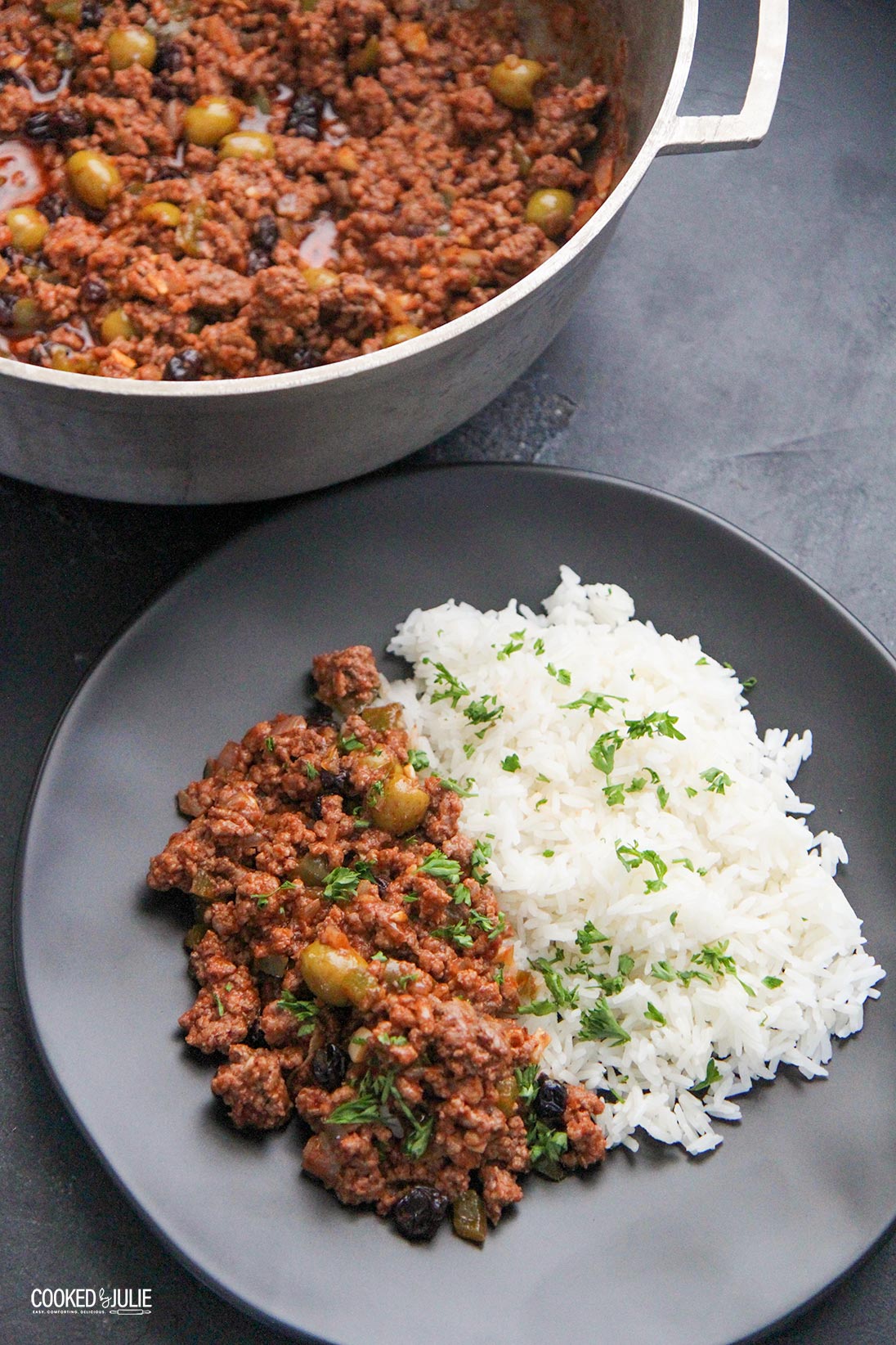 Cuban picadillo with rice on a black plate 