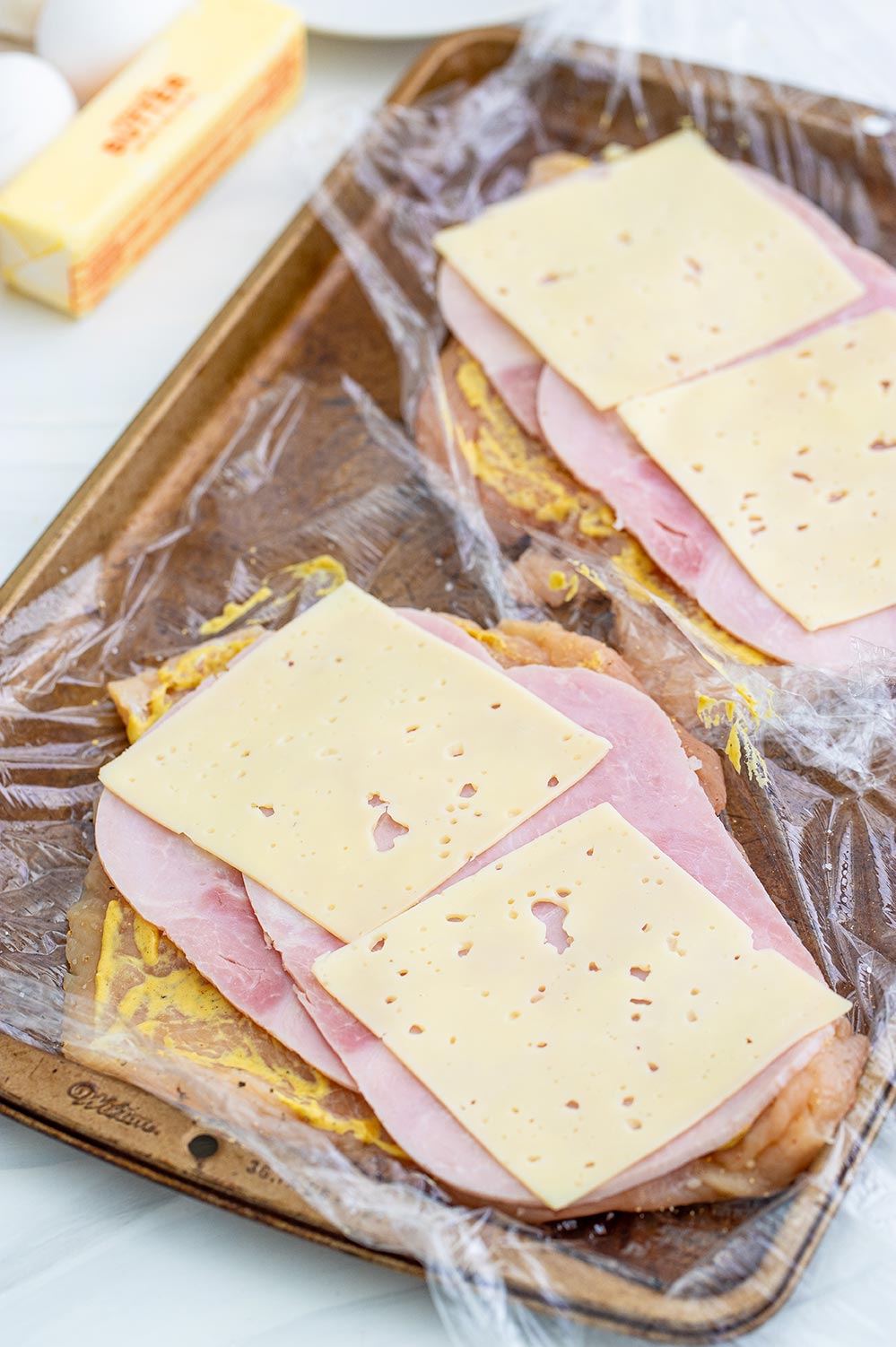 raw chicken breasts, ham, and cheese.