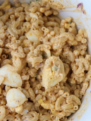 deviled egg pasta salad in a white bowl up close.