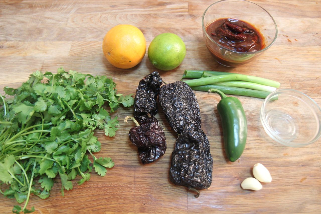 Carne asada taco ingredients include roasted chilis, cilantro, lemon and lime juice, garlic and marinated steak