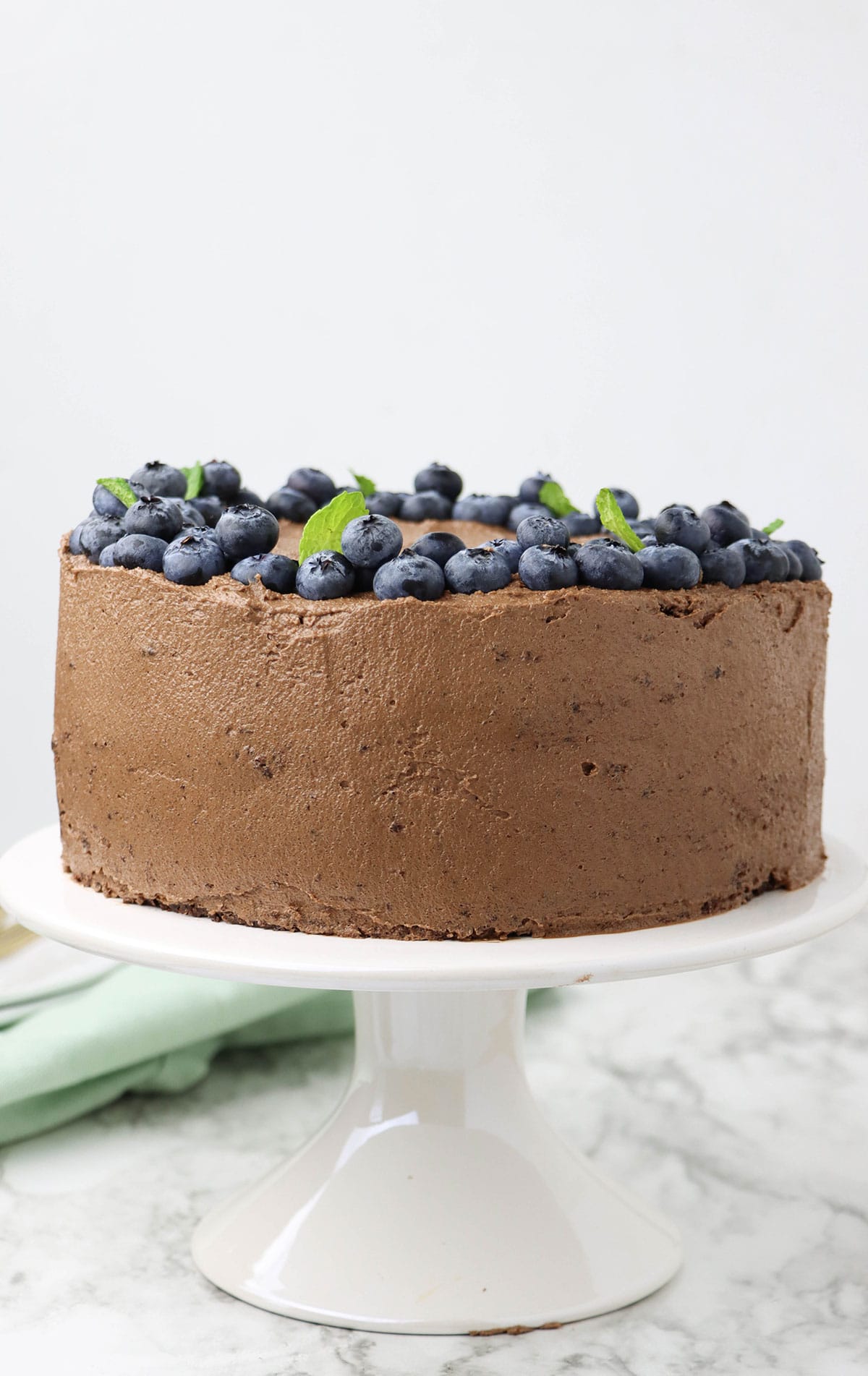 an entire cake on a white cake stand. 