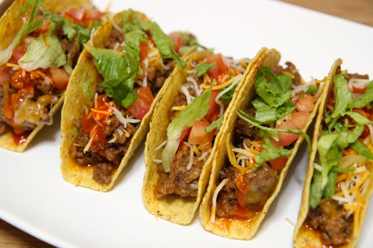 Crispy shell beef tacos with cheese, tomatoes and lettuce. 