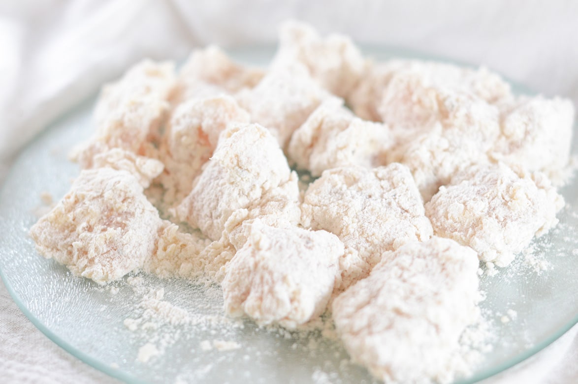 chicken coated in flour on a plate 