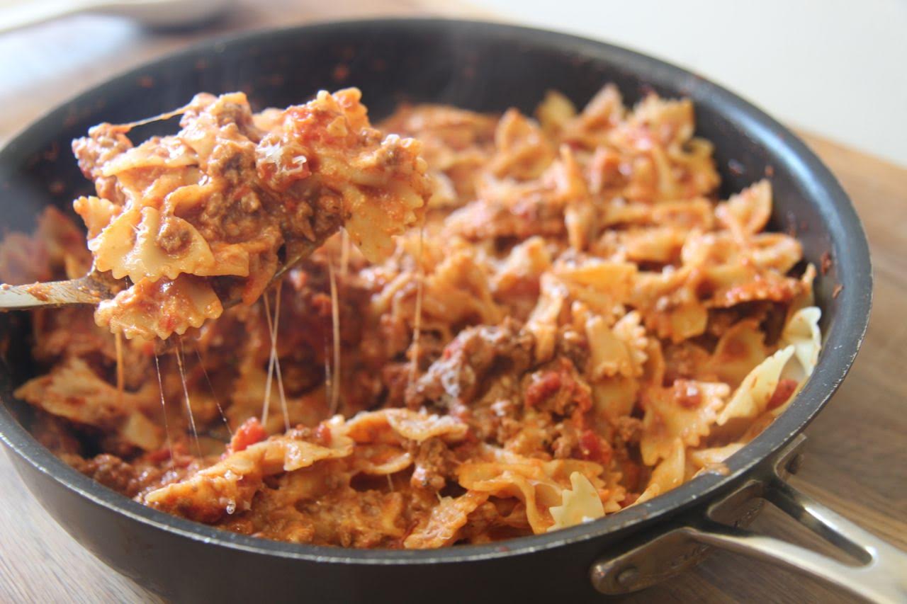 Bowtie pasta mixed with a spicy meat sauce and creamy cheese
