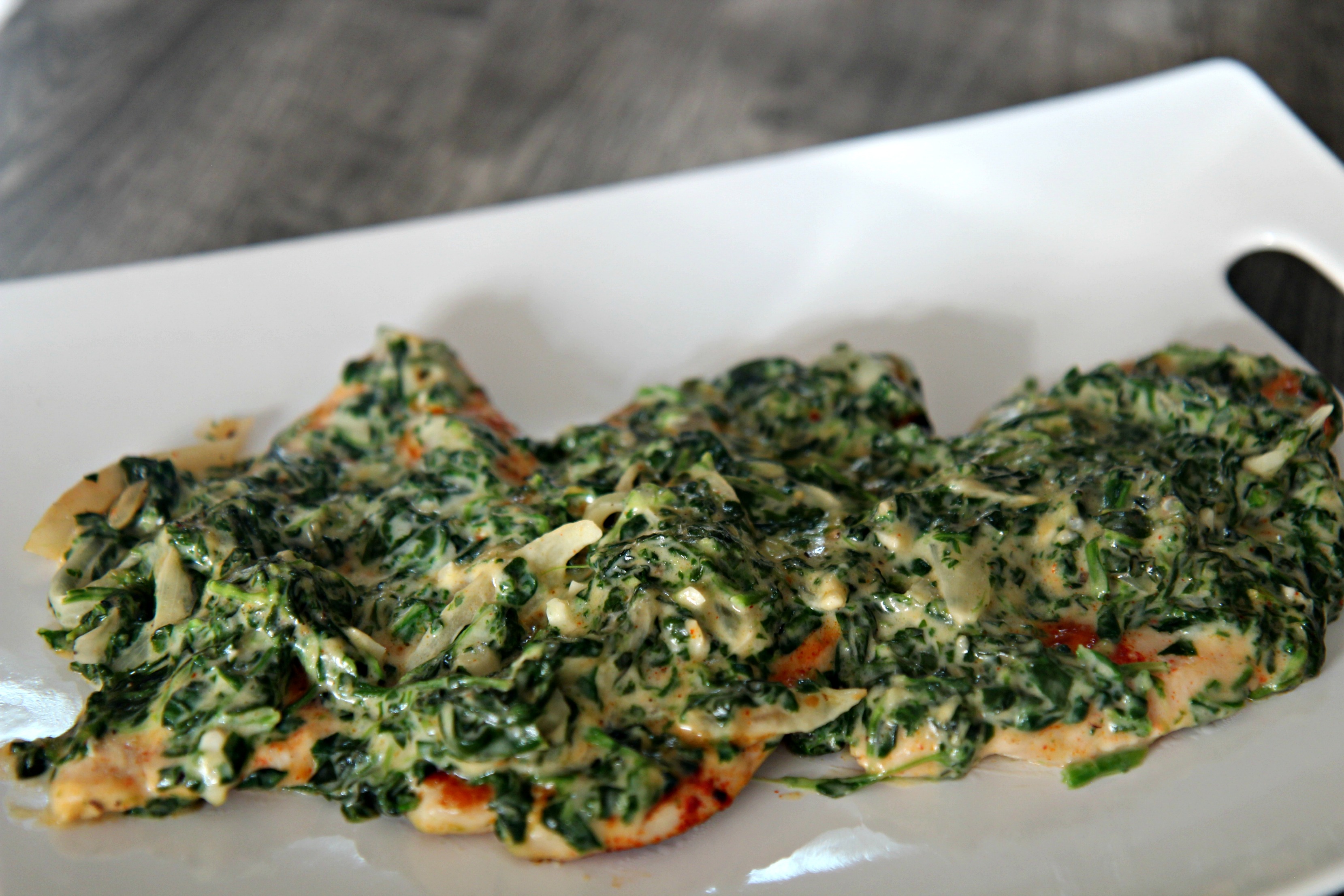 Tender and juicy chicken topped with delicious creamed spinach