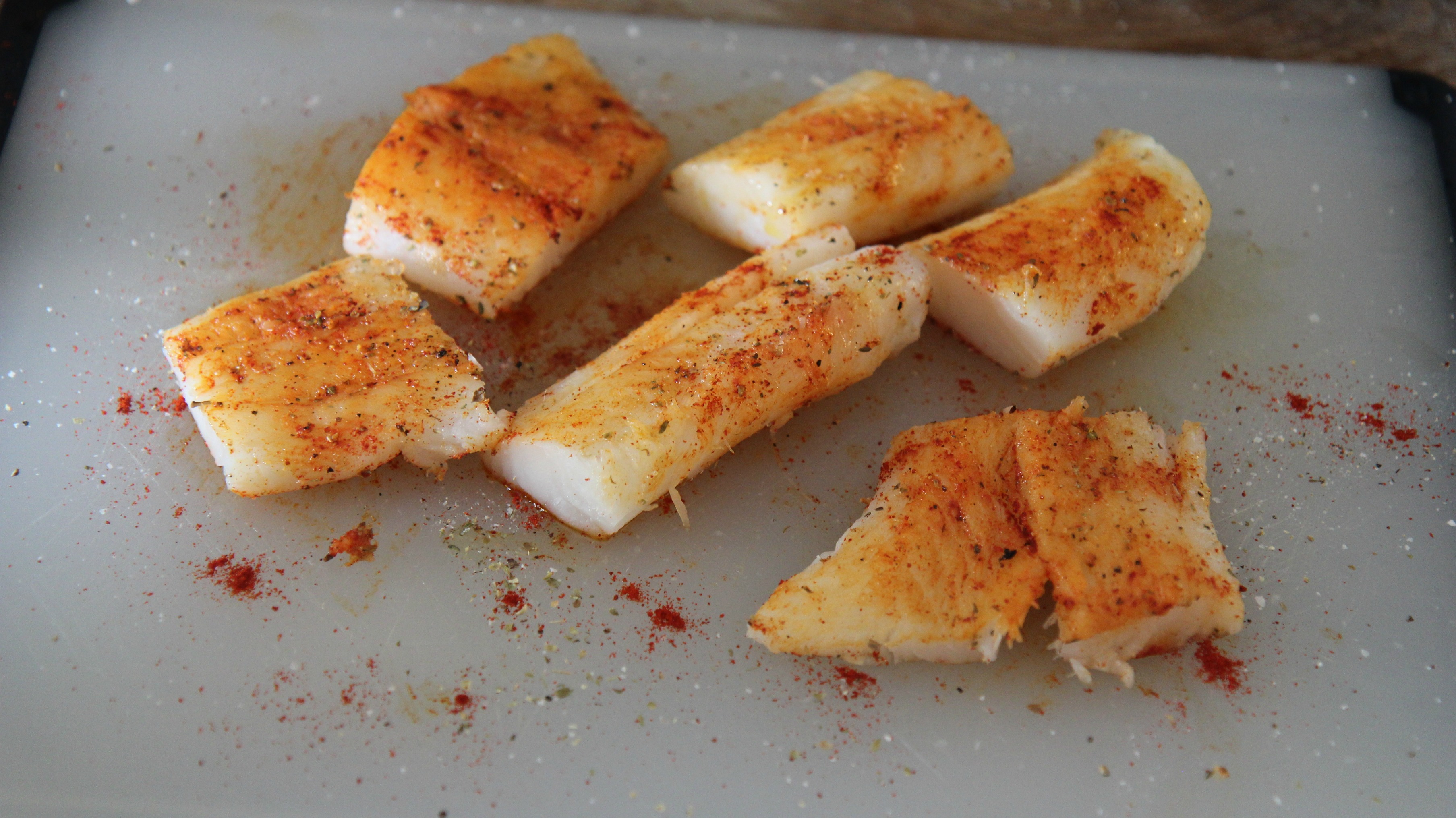 For this skillet cod dinner, you want to season your fish before cooking. Use a blend of spices you love, like chili powder for a little spice. 
