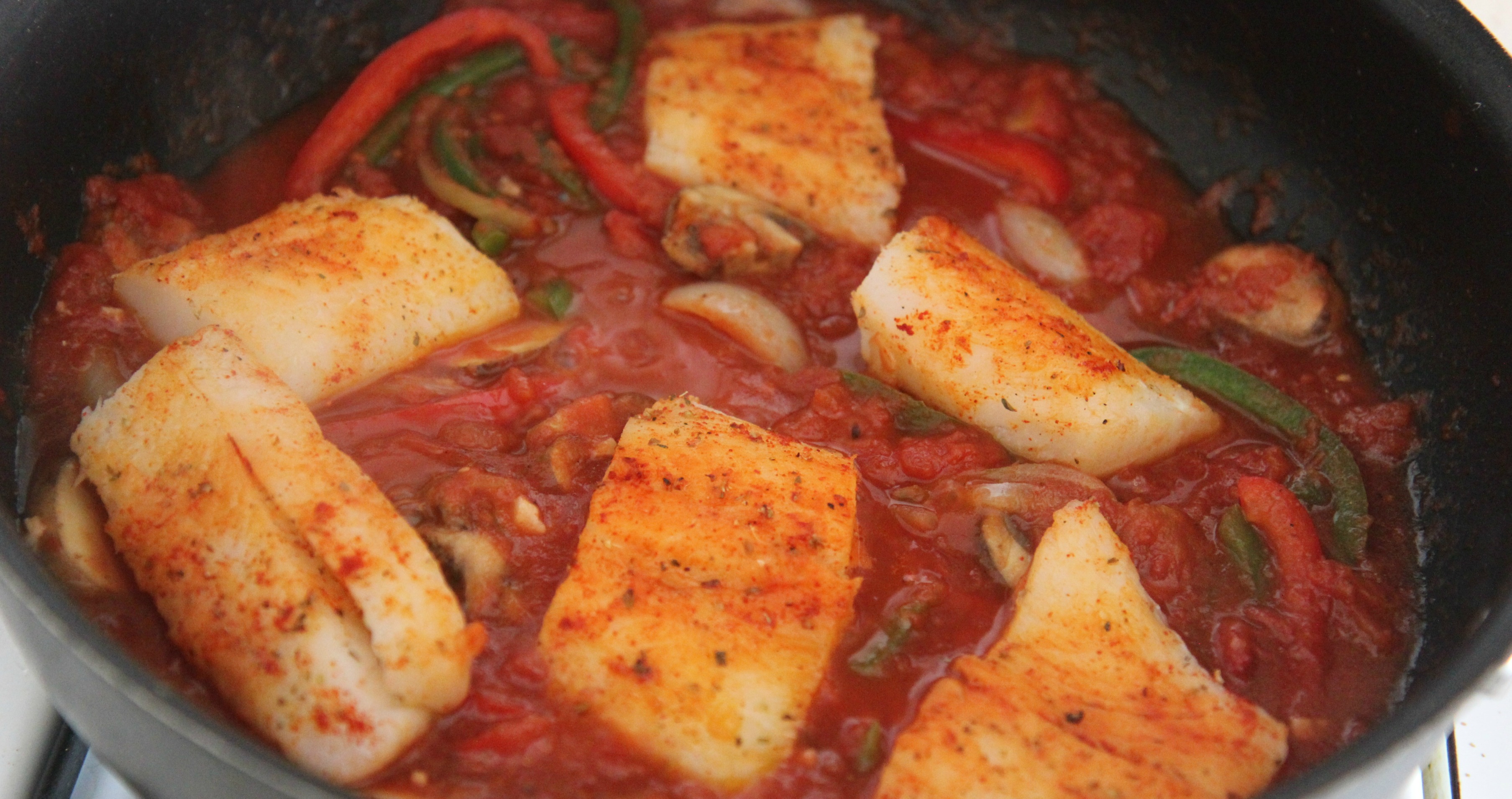 Cook the seasoned cod fish with your tomato sauce and vegetables for 12-15 minutes until fully cooked. 