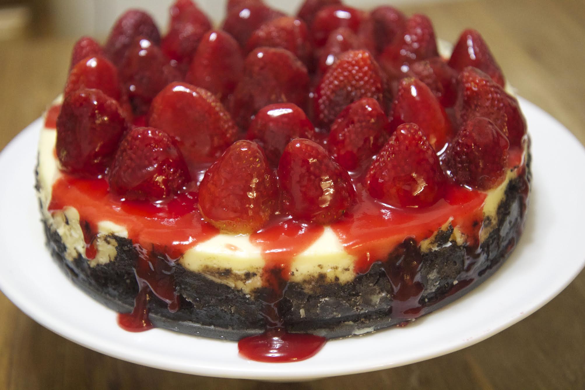 This homemade Oreo cheesecake is topped with fresh strawberries, making it the perfect dessert.