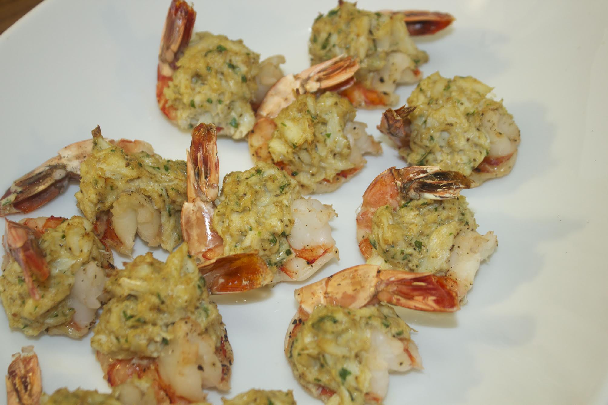 stuffed shrimp on a white platter 