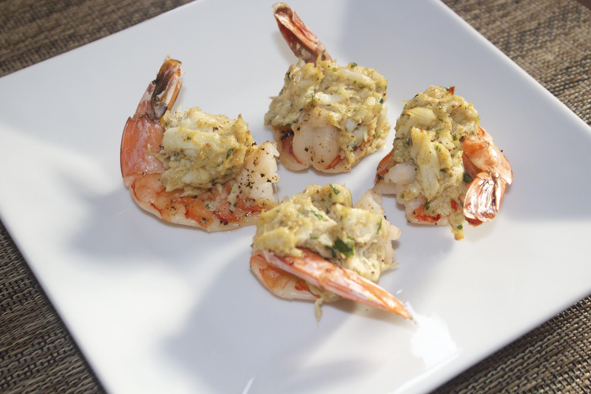 four stuffed shrimp on a white plate 