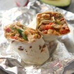 tex mex grilled chicken burrito on aluminum foil.