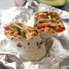 tex mex grilled chicken burrito on aluminum foil.
