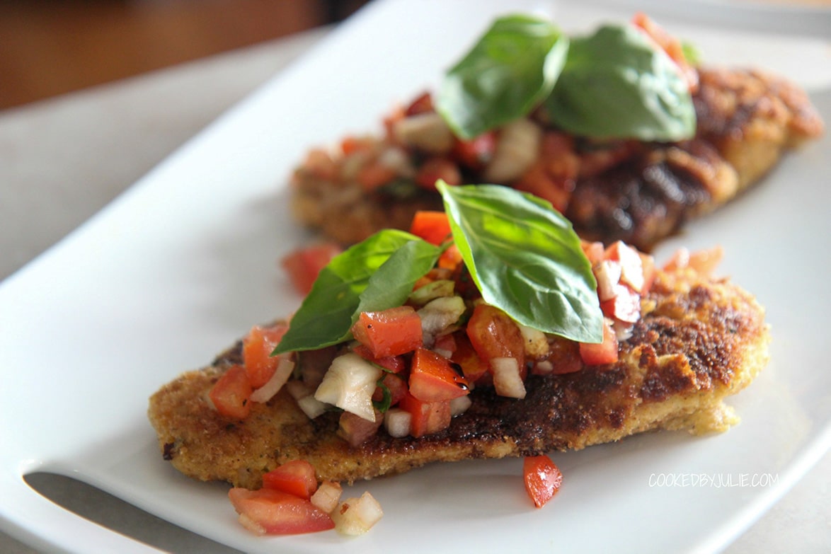 two servings of chicken bruschetta on a white plate.