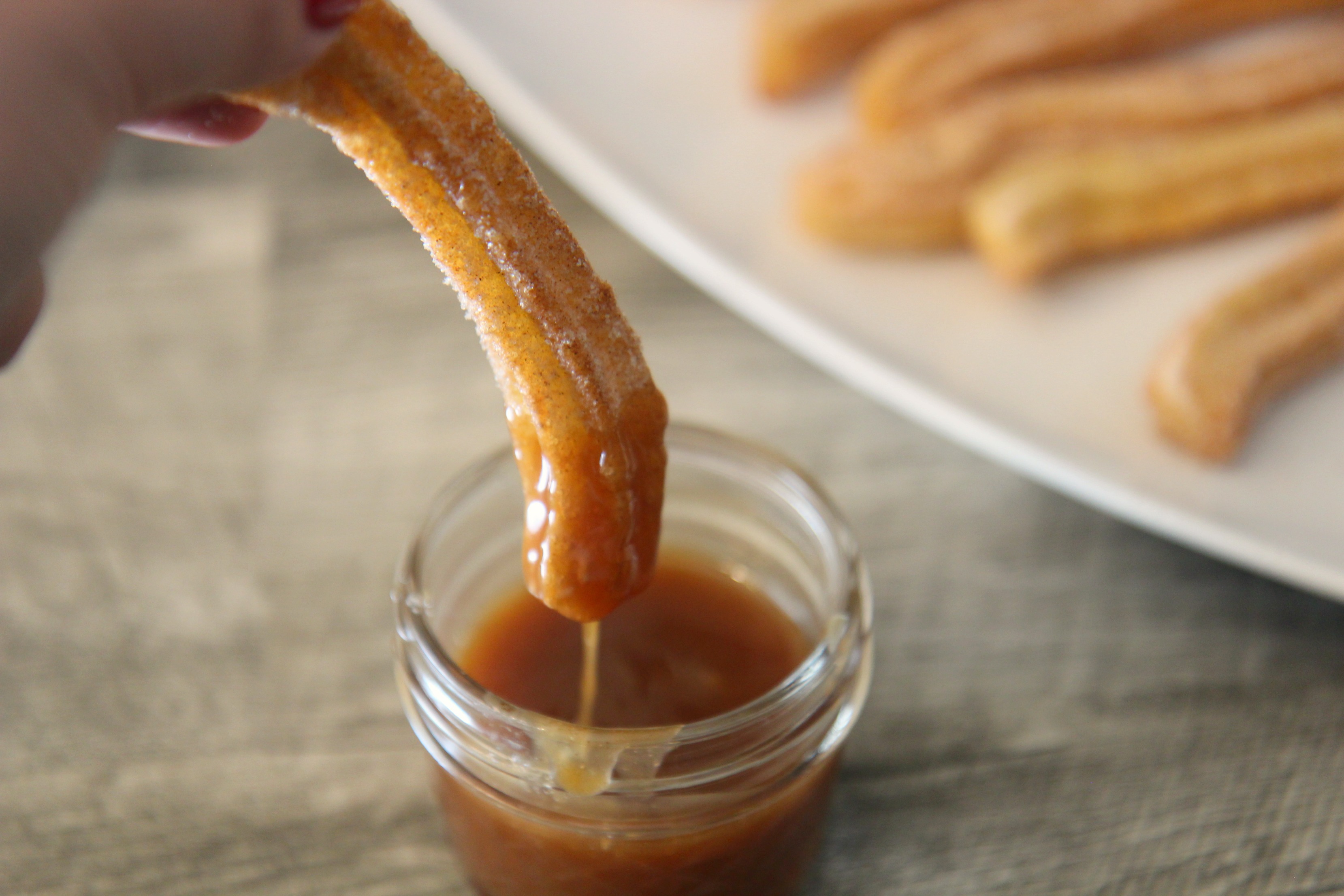 churro dipped in caramel sauce