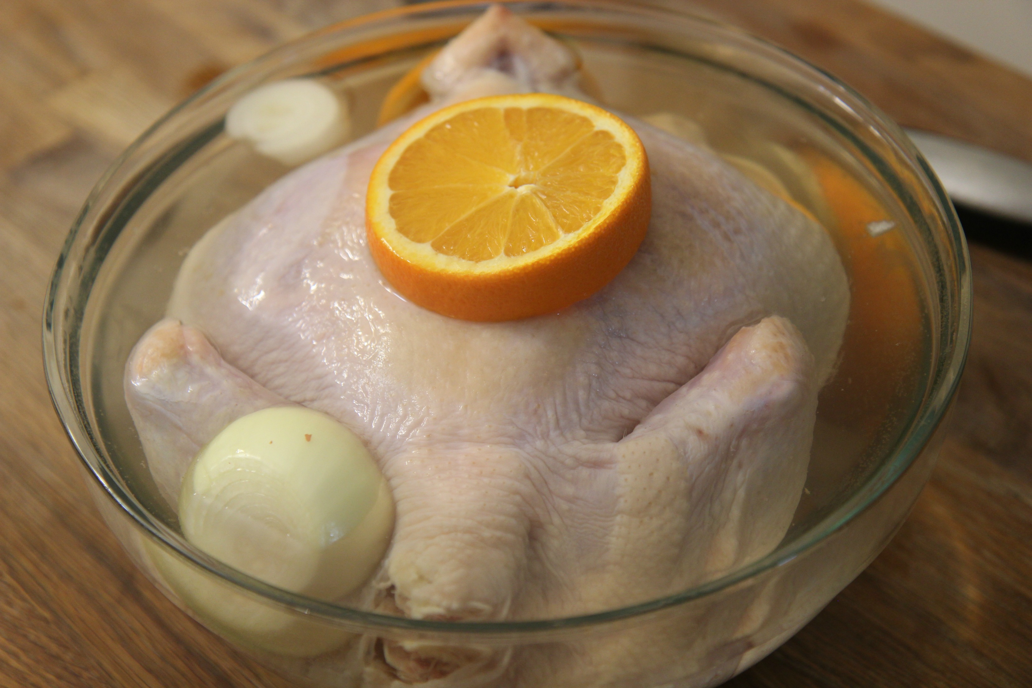 Brine the chicken in a mixture of water, salt and sugar with garlic, onions and oranges