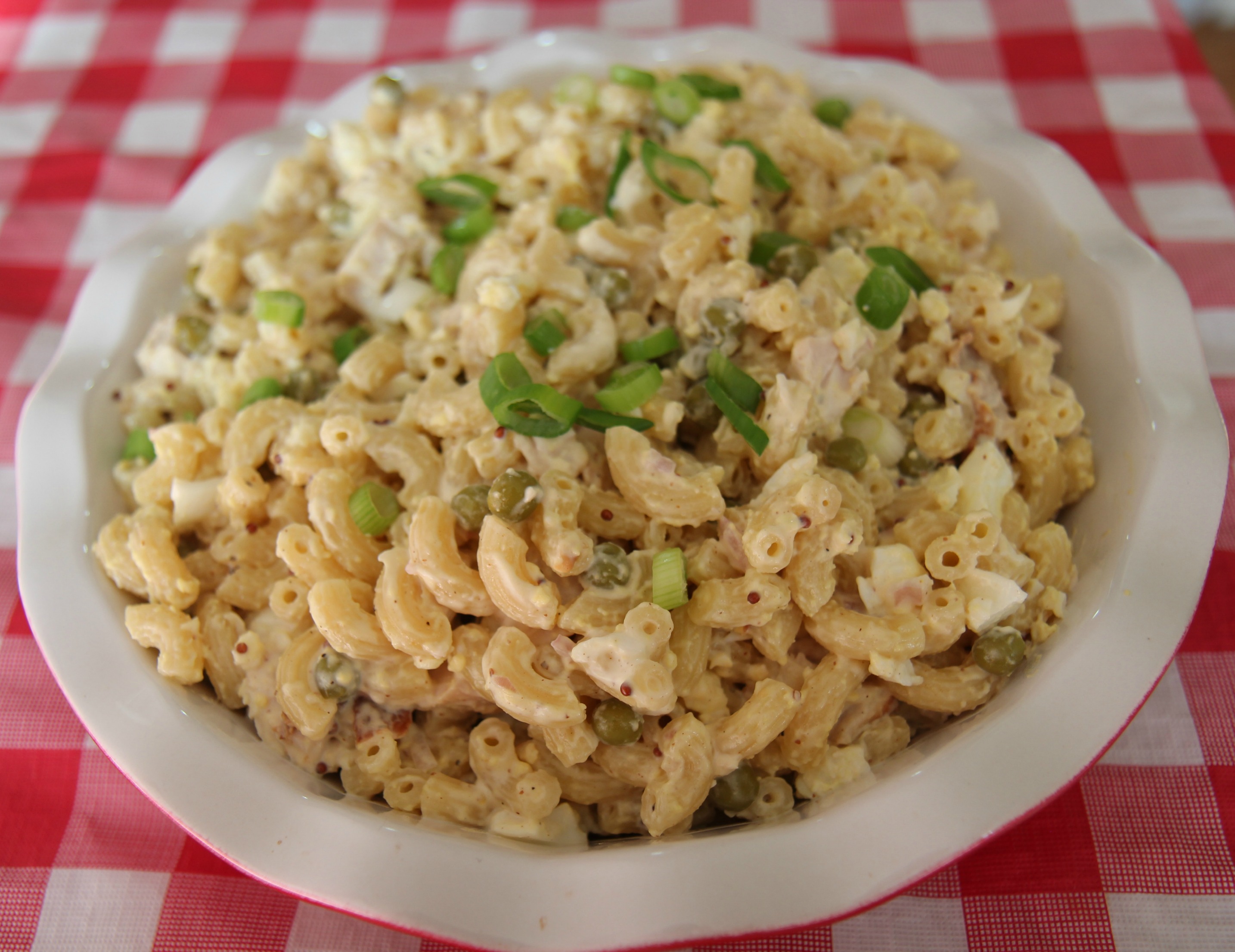 Creamy chicken macaroni salad with onion for a fresh bite of flavor.