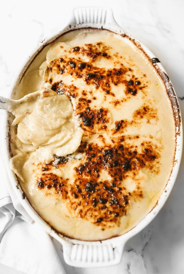 scalloped potatoes in a white casserole dish.
