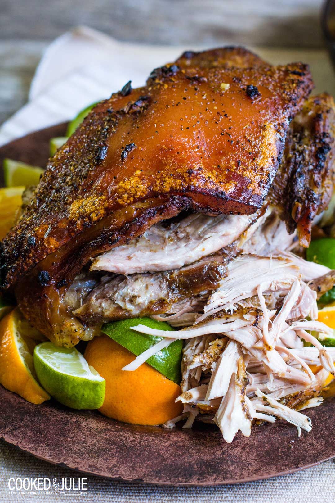 pernil up close with limes and oranges. 