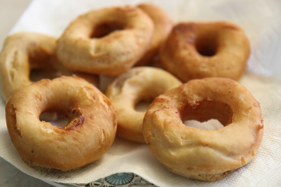 fried donuts on a plate with paper towel. 