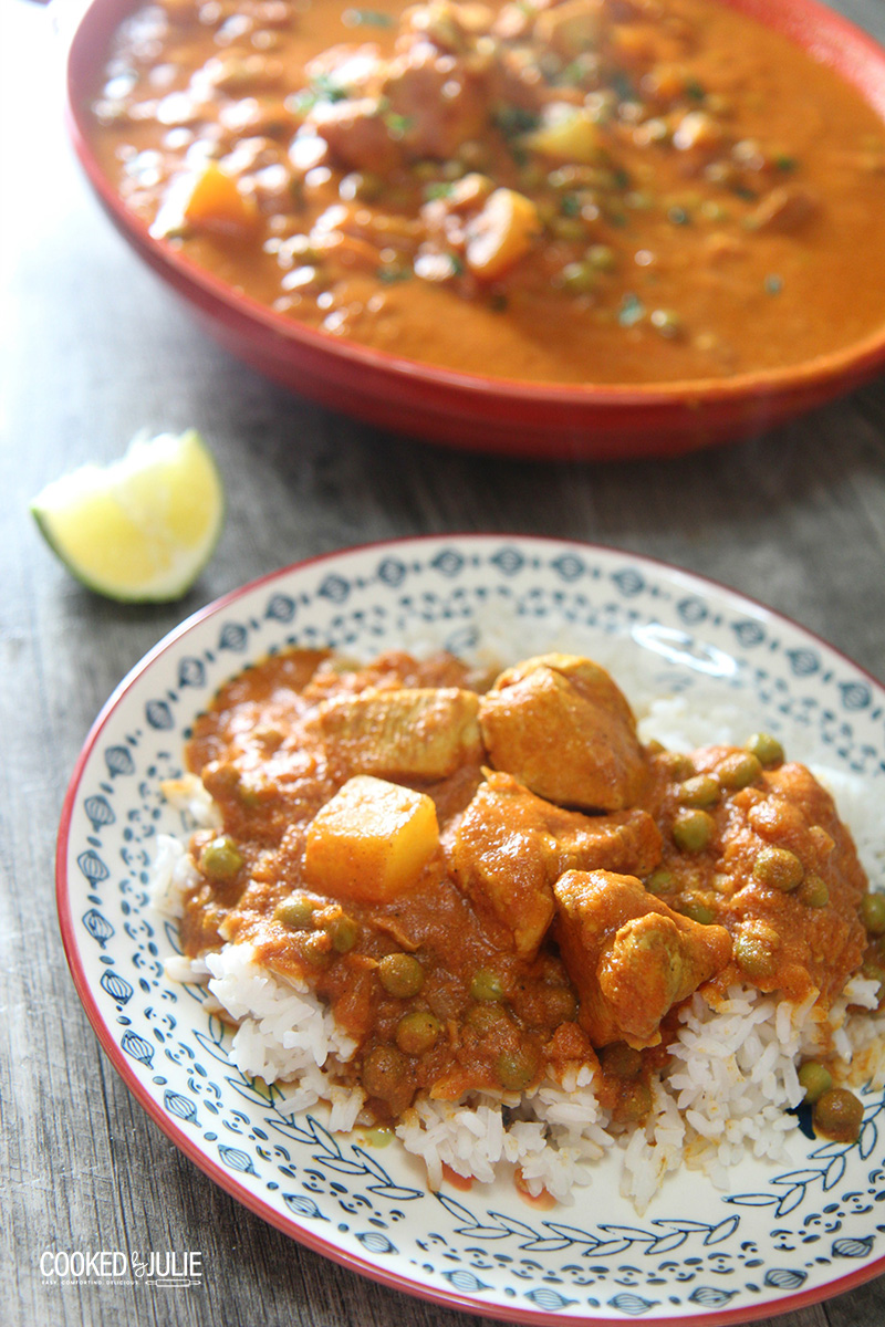 coconut chicken curry over rice on a small plate 