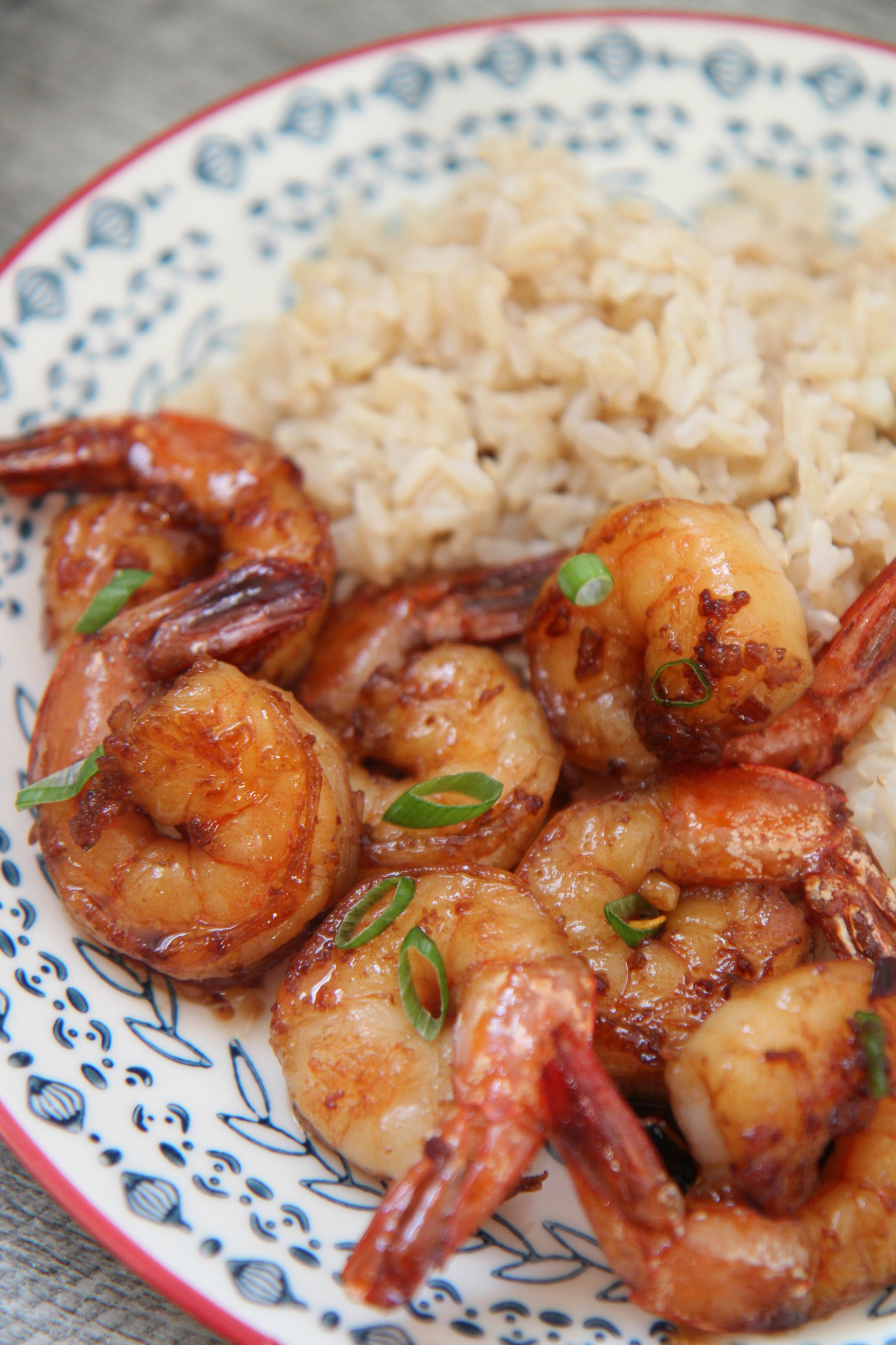 honey garlic shrimp with scallions and brown rice.