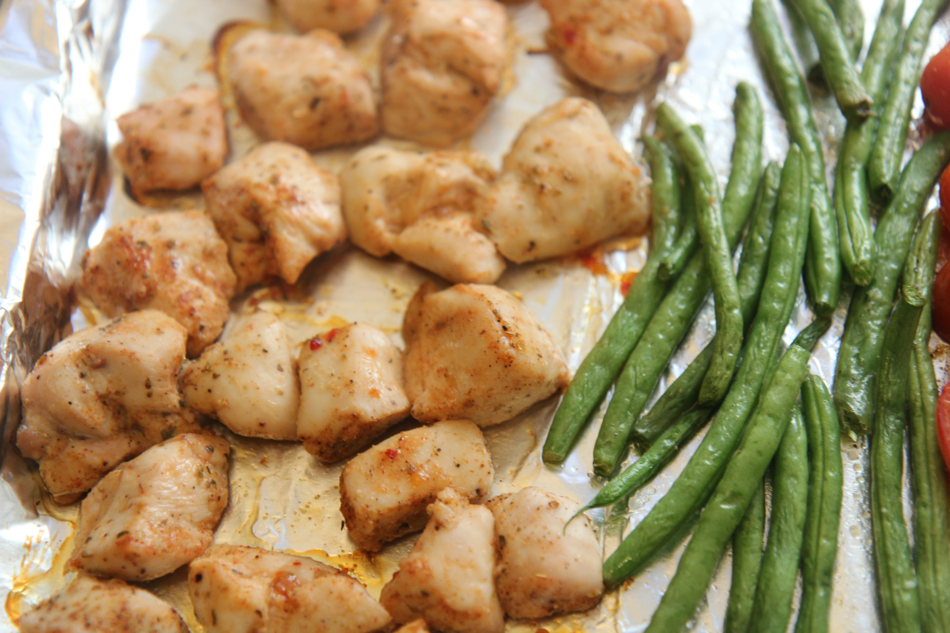Chicken breast chunks and green beans seasoned and baked for a one-pan dinner. 