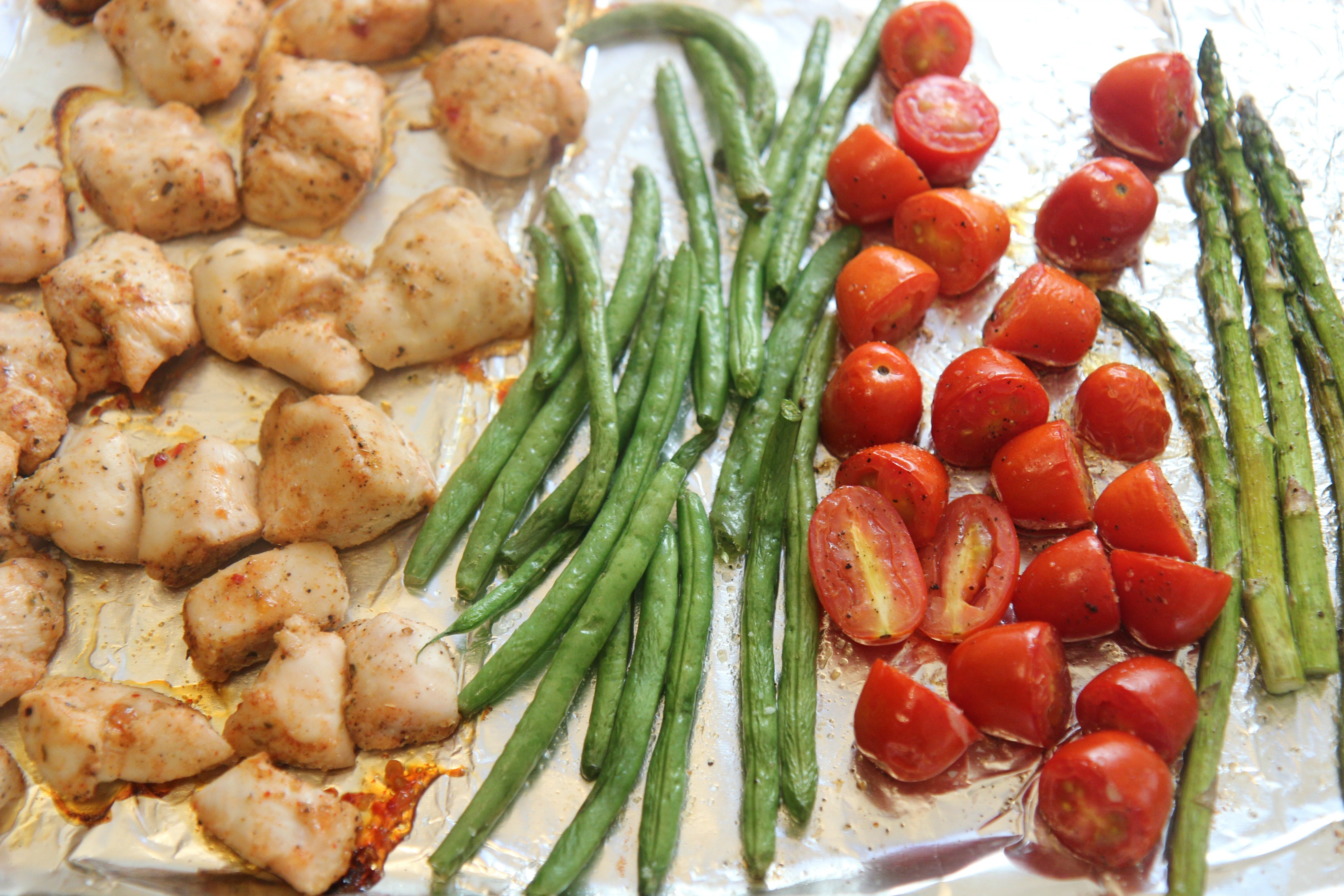 One Pan Chicken and Veggies - Seasoned chicken with green beans, asparagus, and cherry tomatoes.