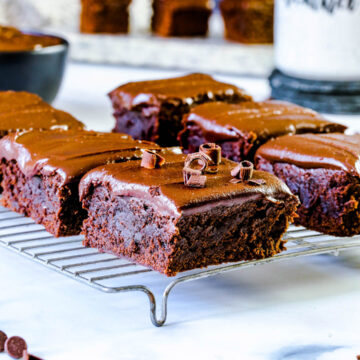 six chocolate brownies on a cooling rack