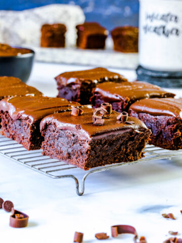 six chocolate brownies on a cooling rack