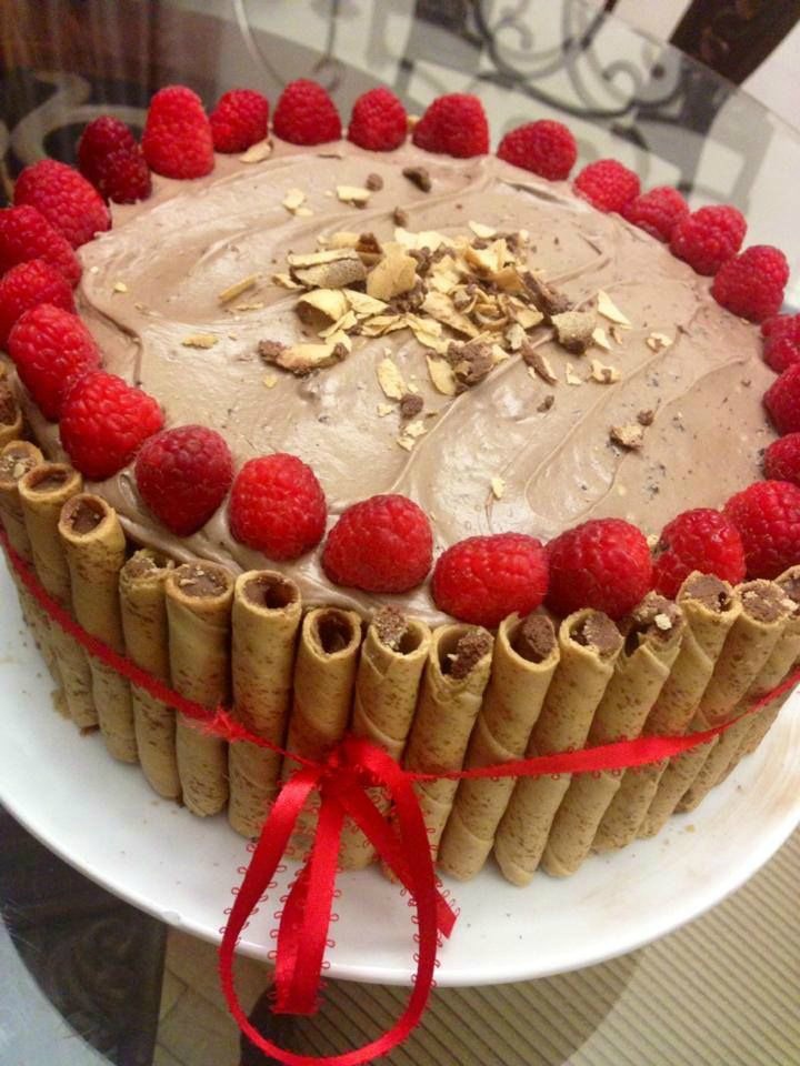 This Nutella cake is made with a Nutella frosting and topped with raspberries and almond slices