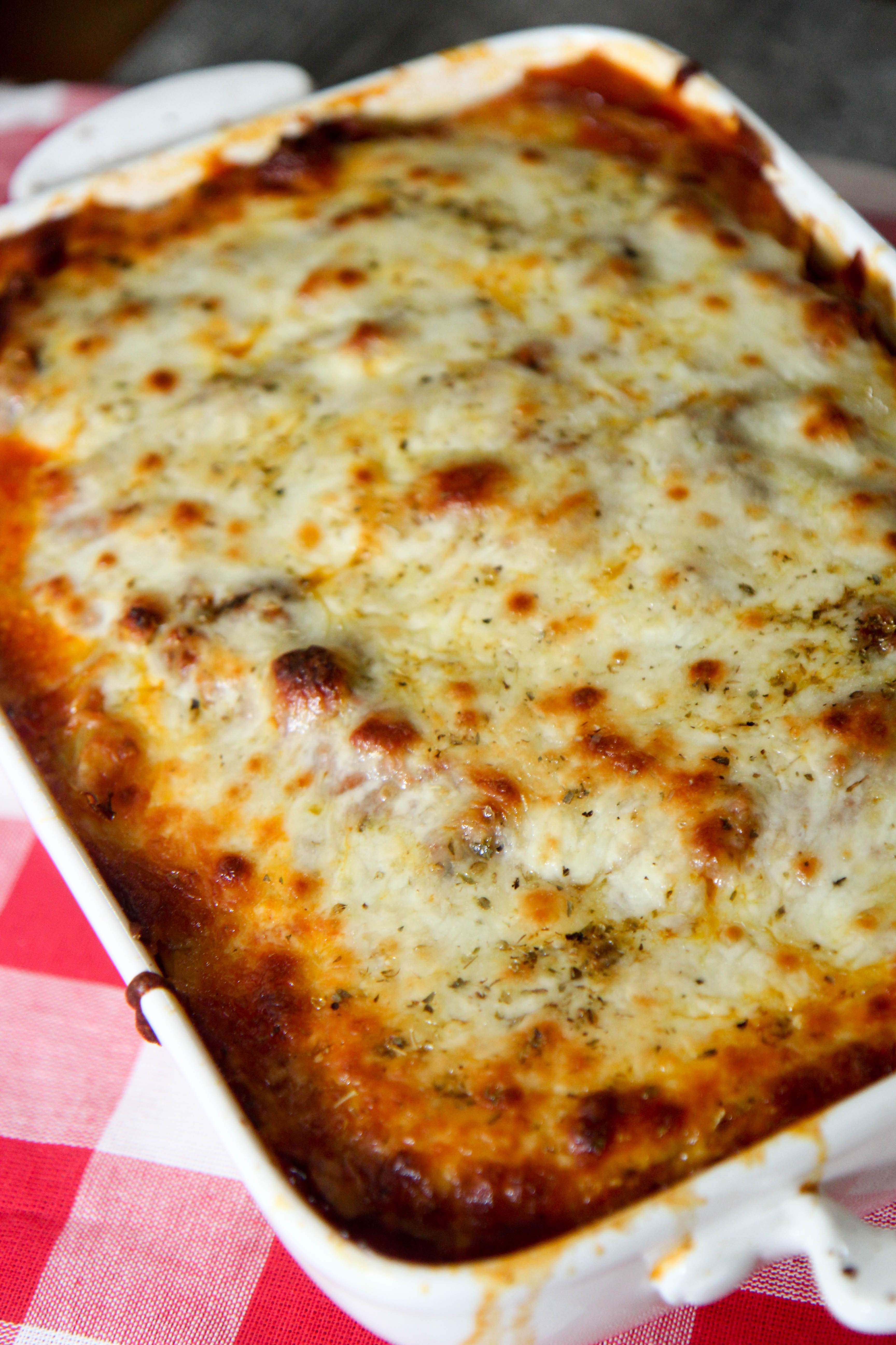 a cheesy cabbage low carb lasagna in a white baking dish 