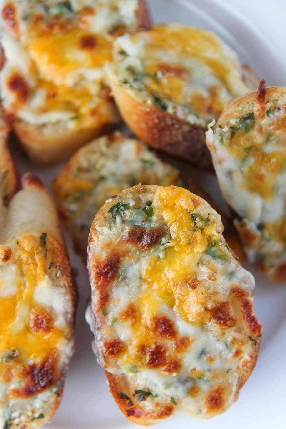 baked cheesy garlic on a white plate.