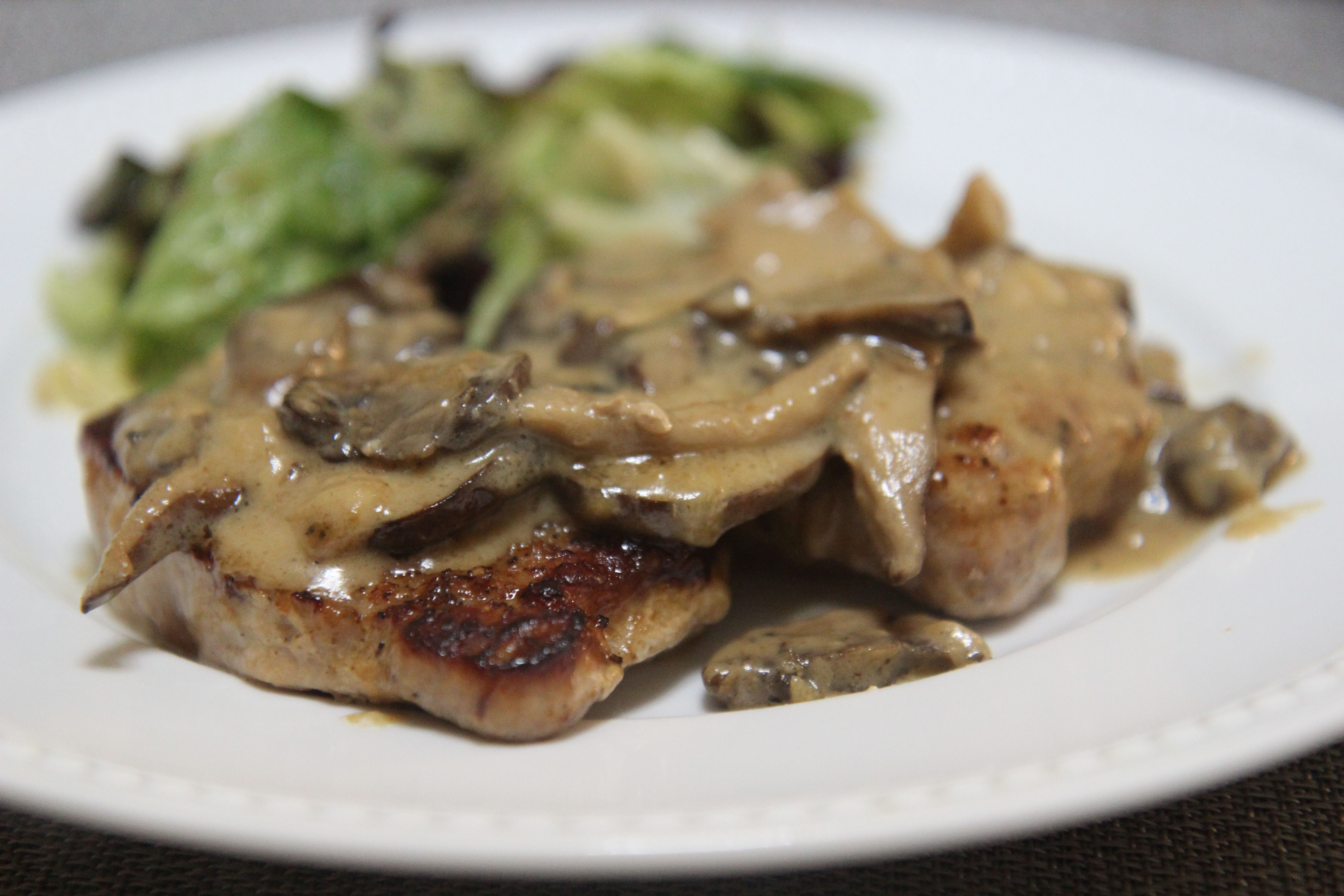 These pork chops are dressed in a creamy garlic sauce with mushrooms and onions.