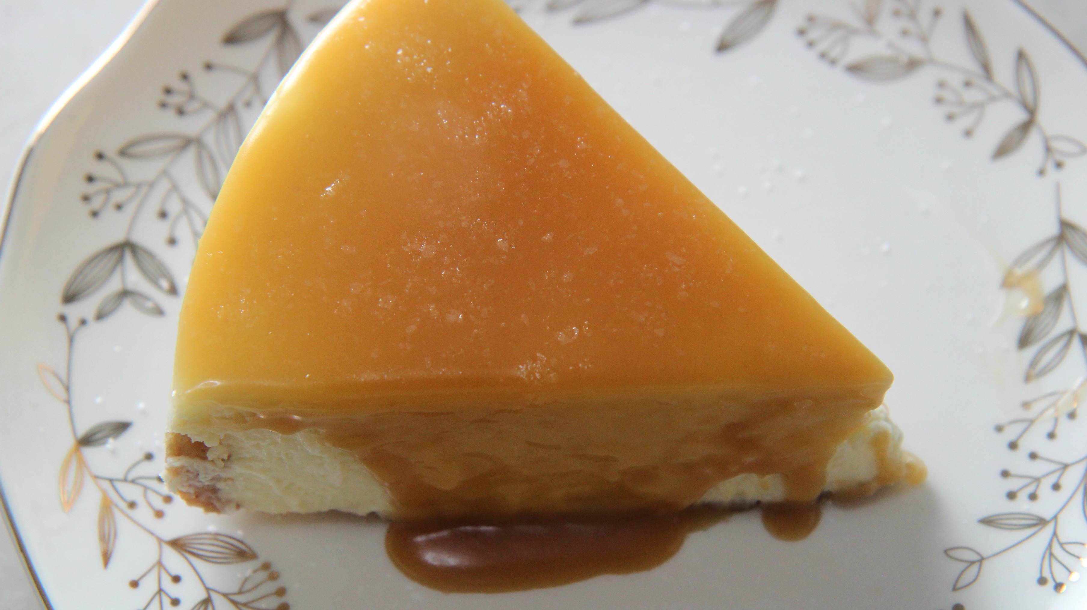 a slice of salted caramel cheesecake on a white plate 