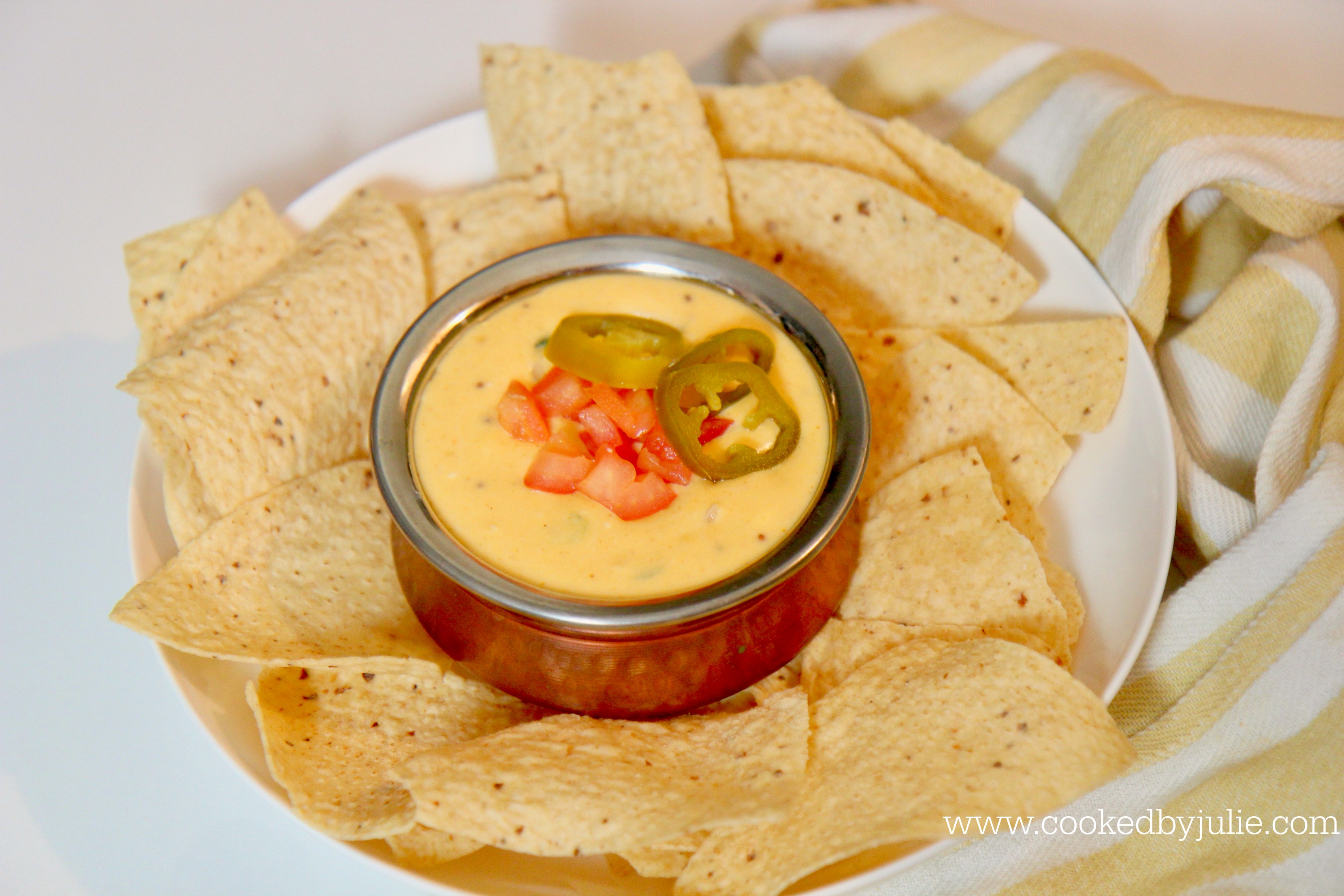 Queso dip with tortilla chips is a perfect game day treat 