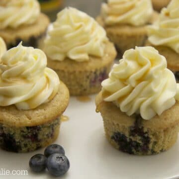 blueberry pancake cupcakes served on a white platter with fresh blueberries
