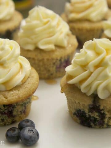 blueberry pancake cupcakes served on a white platter with fresh blueberries