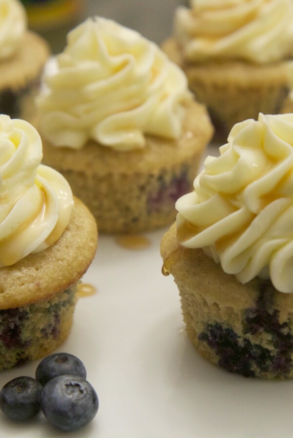 blueberry pancake cupcakes served on a white platter with fresh blueberries