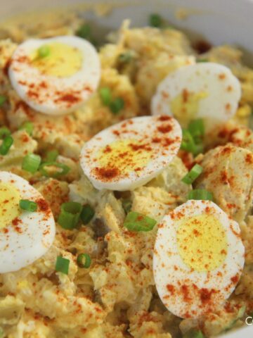 potato and egg salad in a white bowl.