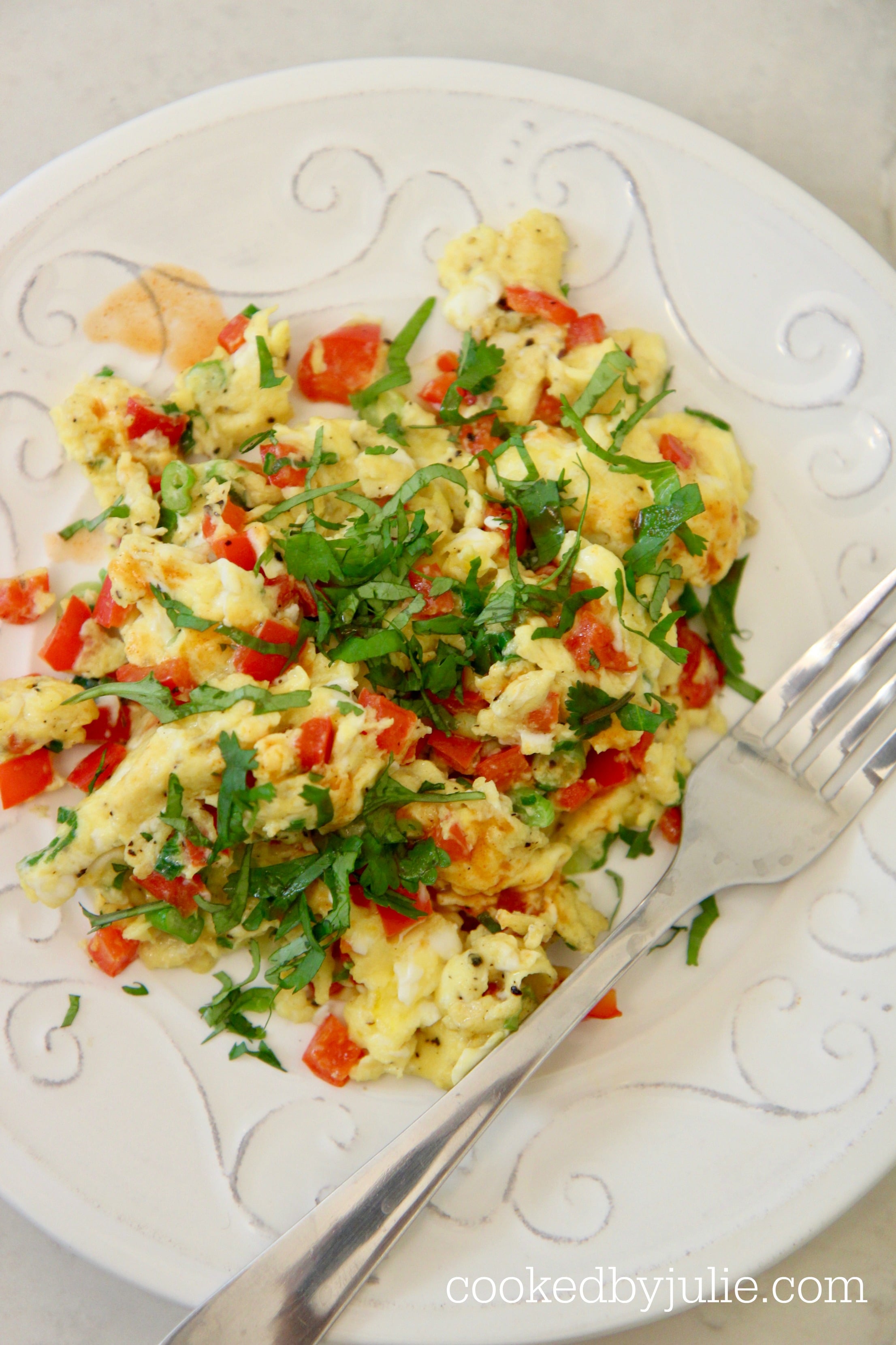 scrambled eggs with onions, peppers, cilantro, and hot sauce.
