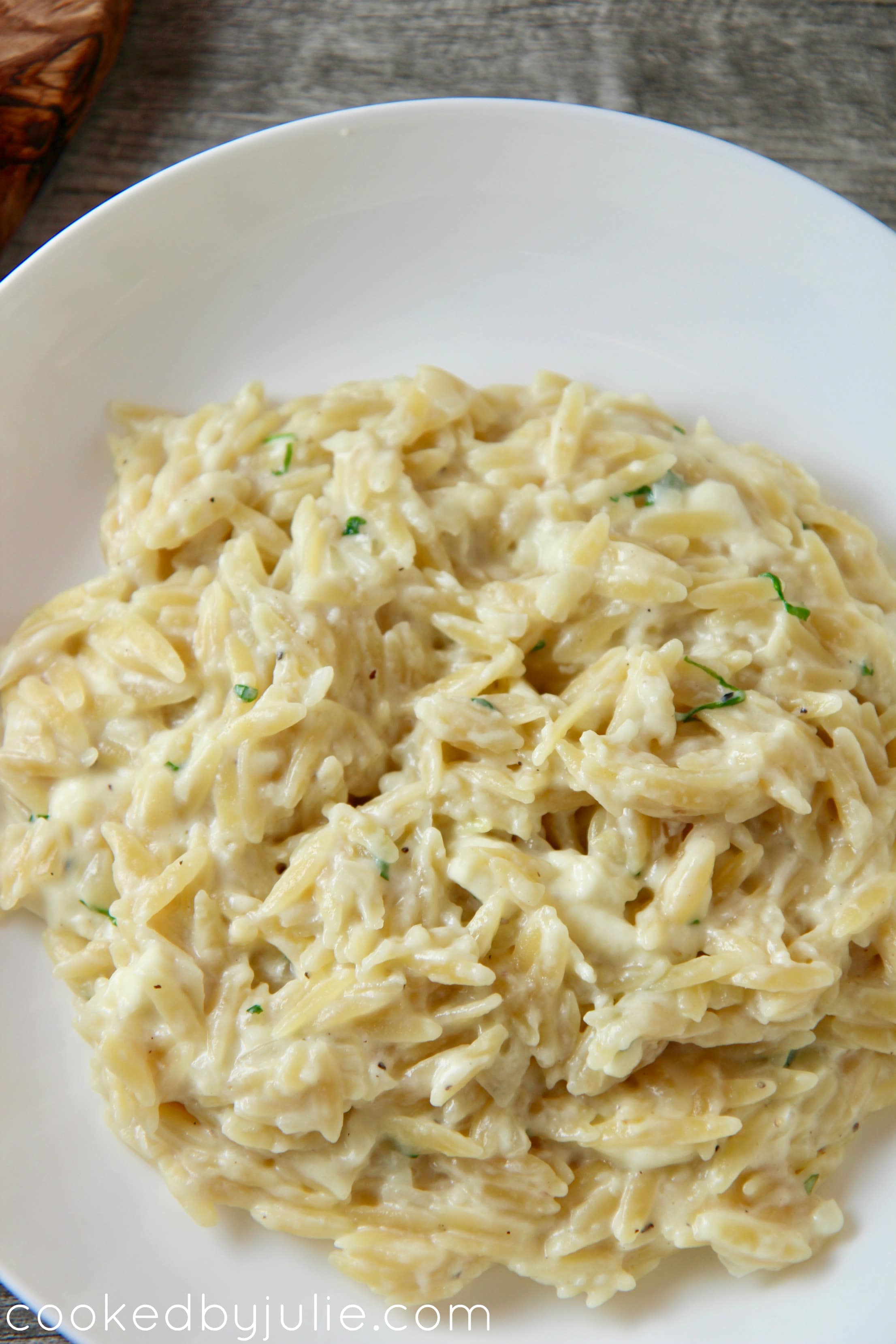 cheese orzo in a white bowl up close. 