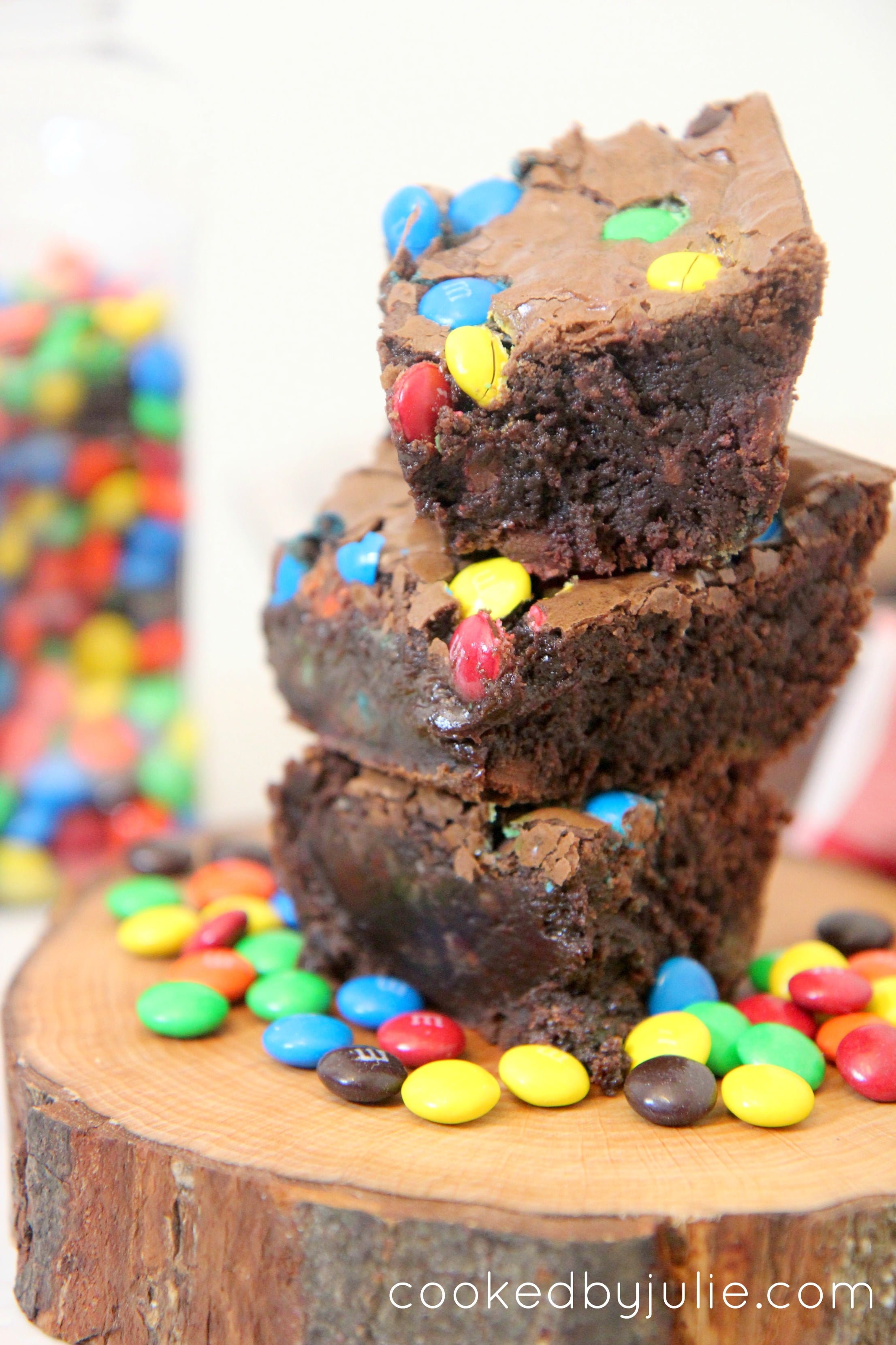 Gooey chocolate brownies sprinkled with M&Ms stacked on top of each other
