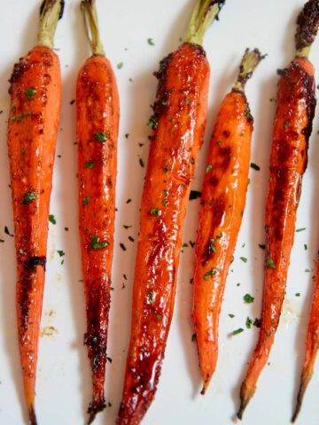 honey garlic carrots on a white platter.