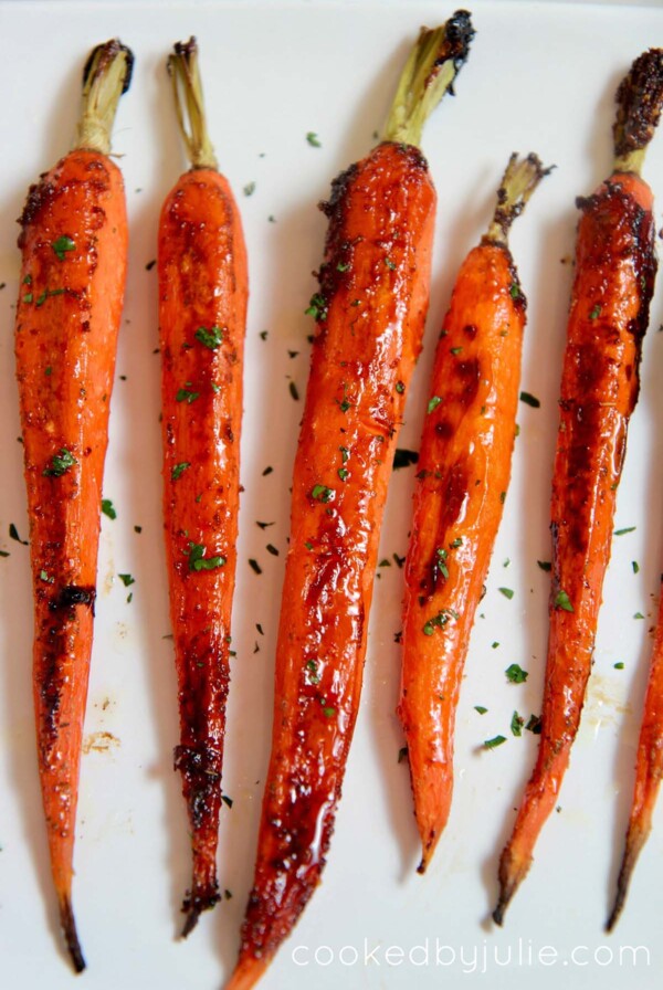 honey garlic carrots on a white platter.