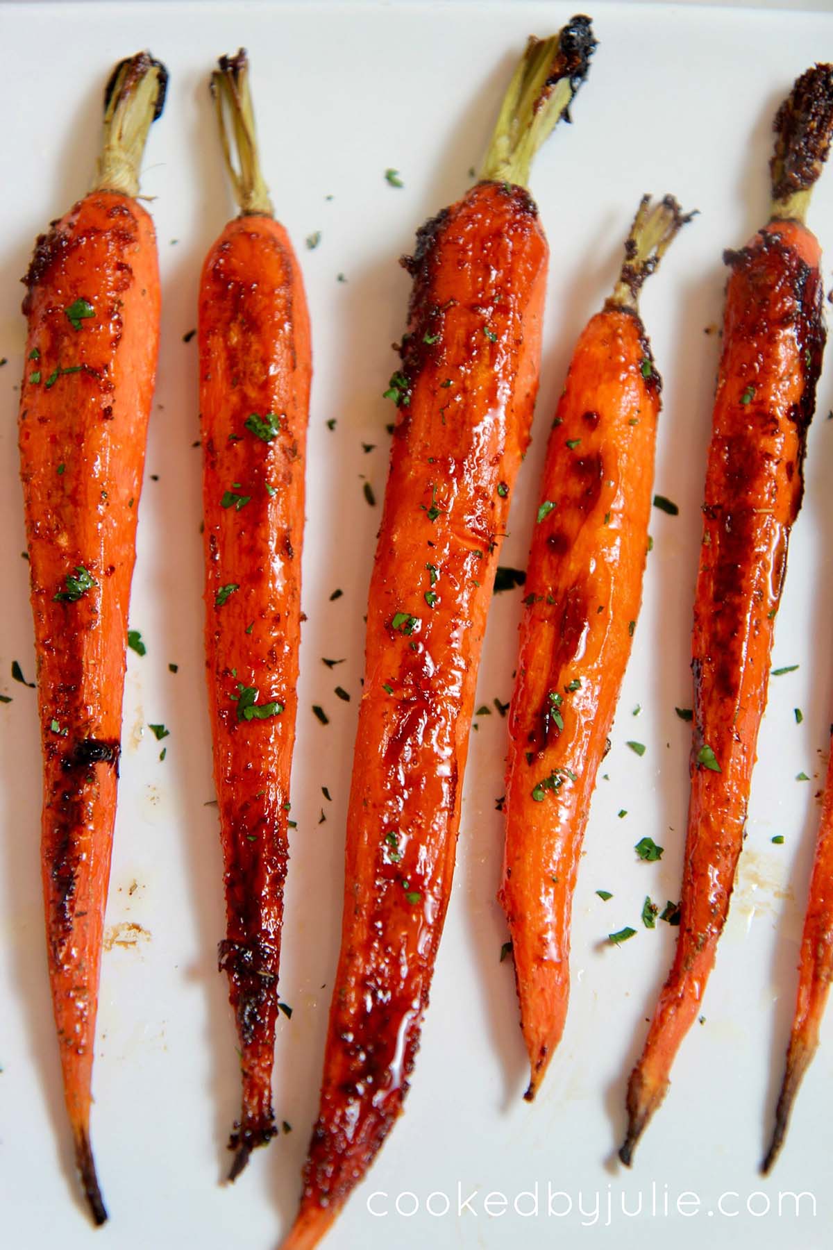 honey garlic carrots on a white platter. 