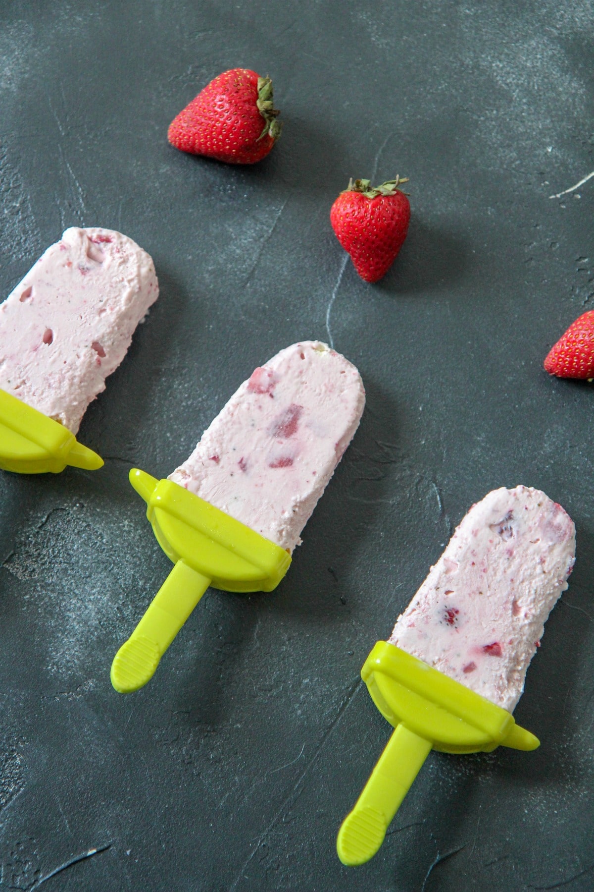 strawberry cheesecake popsicles with strawberry chunks