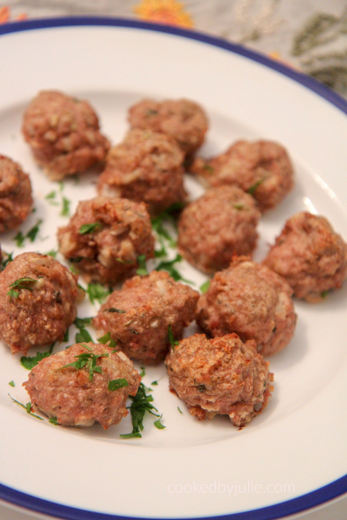 baked turkey meatballs on a white and blue plate 