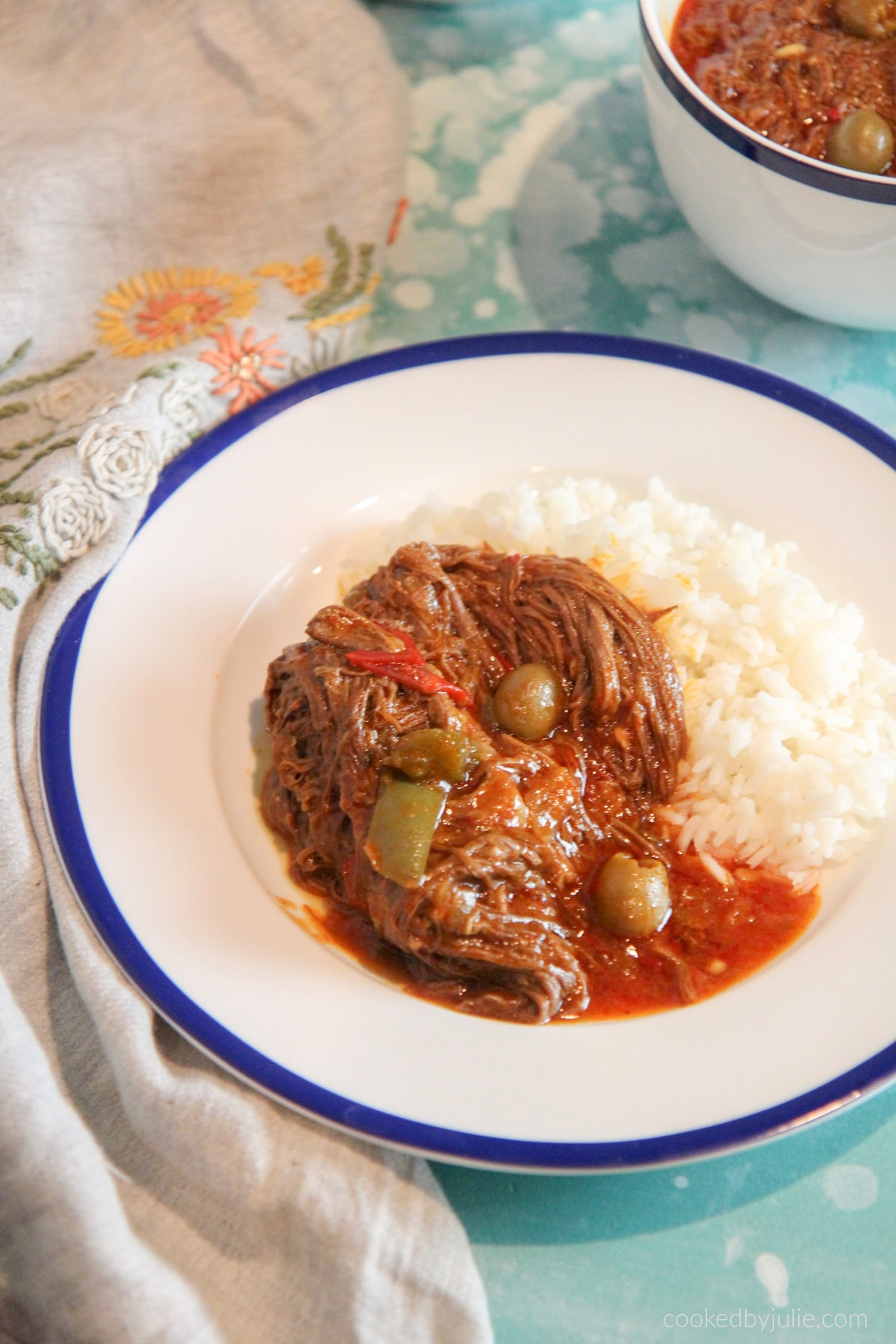 ropa vieja with white rice on a plate.